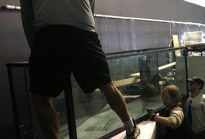 Movers installing a very large glass aquarium